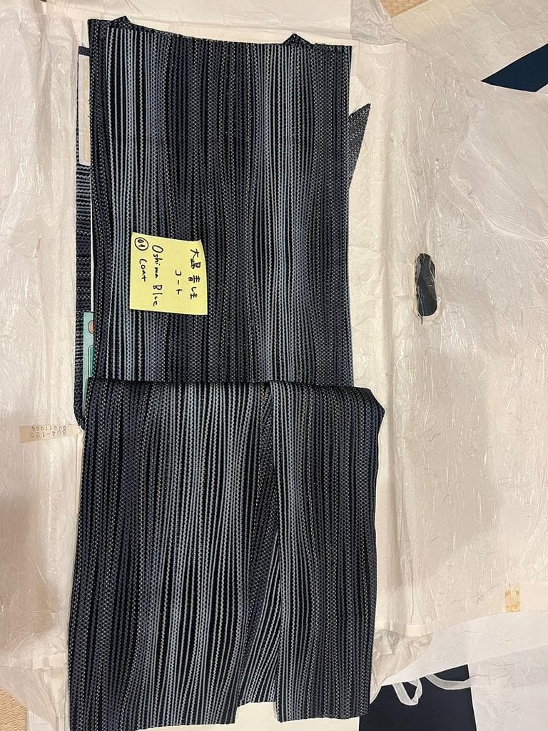 Folded striped coat with a label.