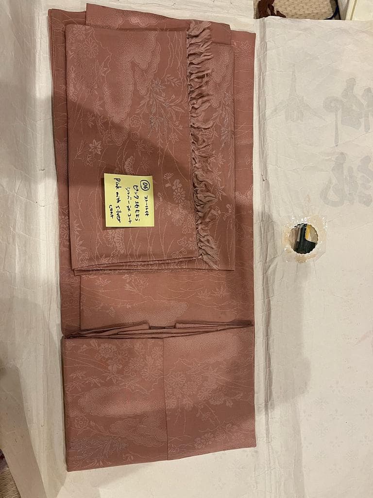 Folded pink coat with floral pattern.