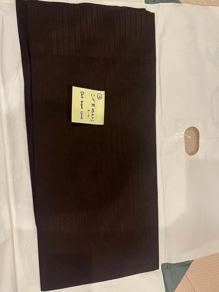 Dark brown coat with subtle stripe pattern.