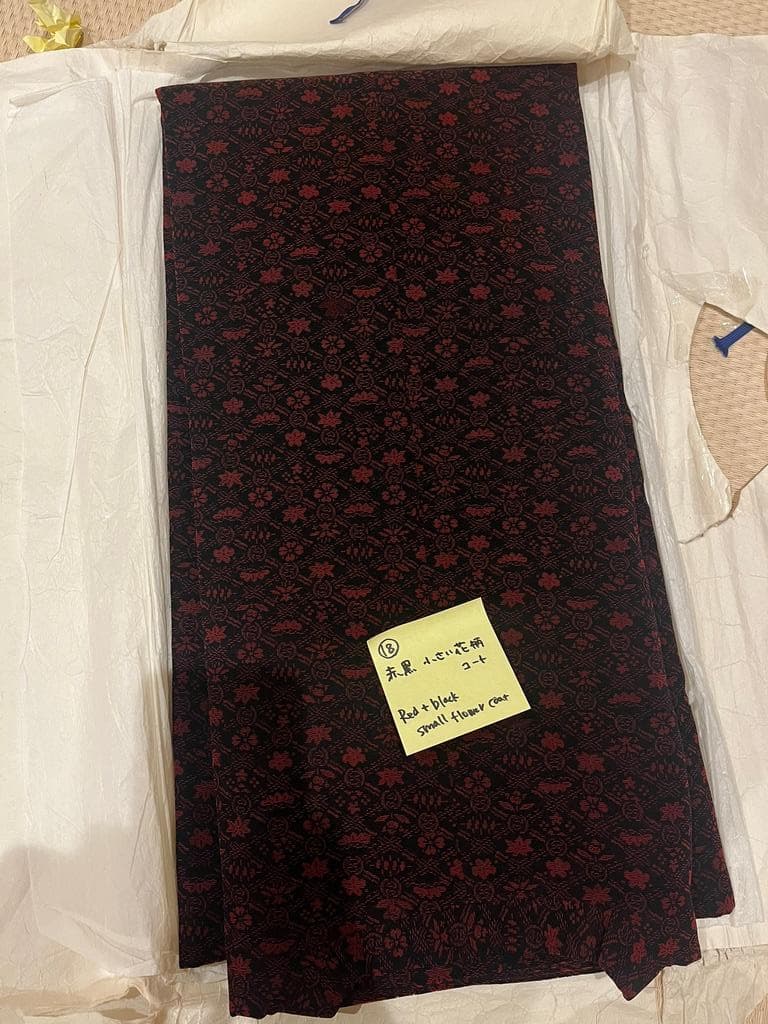 Folded red and black floral coat.